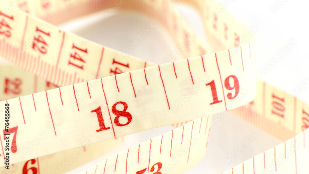 Tape Measure on White Background in Weight Control Concept. Tape Measure on White Background in Weight Control Concept.