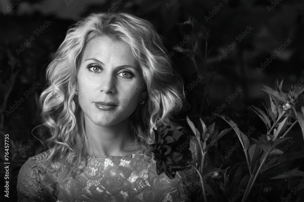 Beautiful girl in the flower garden