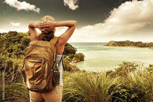 Tourist girl enjoying view of beautiful  hills and sea, travelin photo