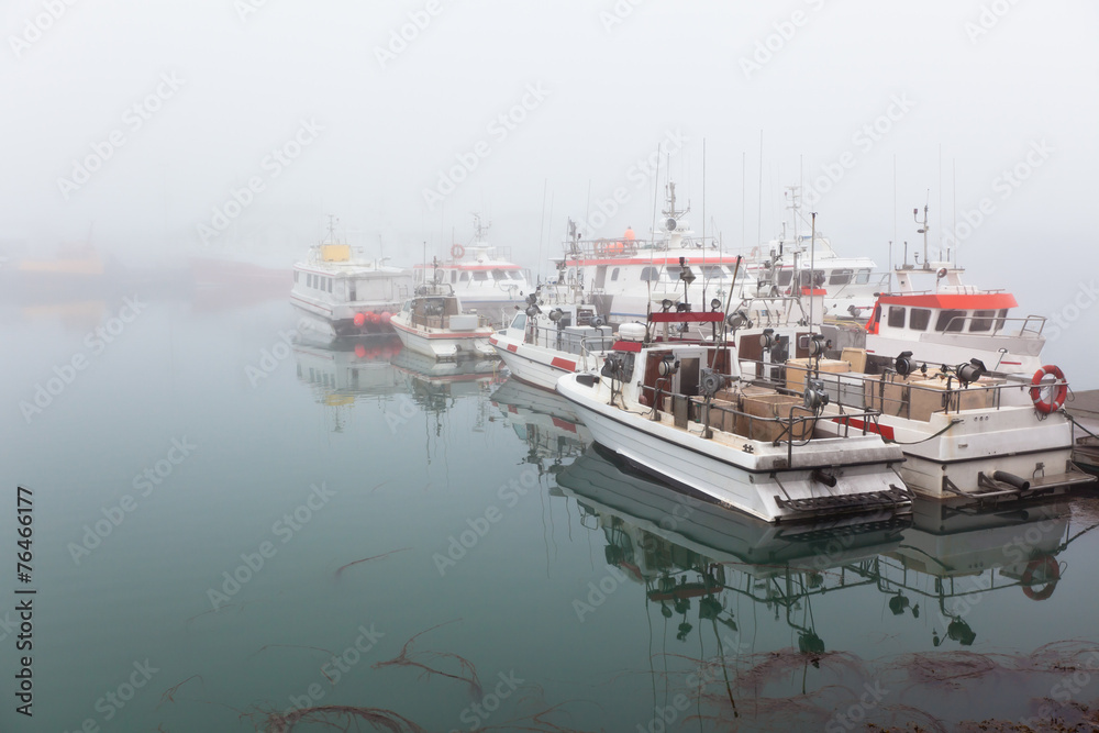 Fishing vessel in a foggy misty morning