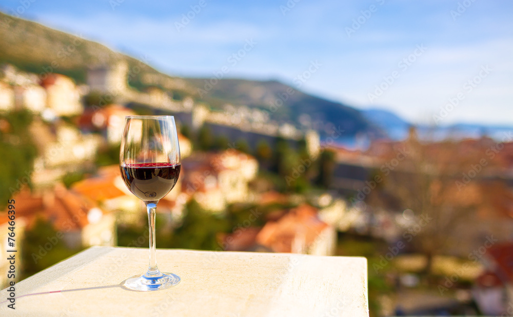 Fototapeta premium Glass of red wine with city view of Dubrovnik. Croatia.