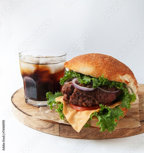 Rustic burgers with a cold drink on wooden