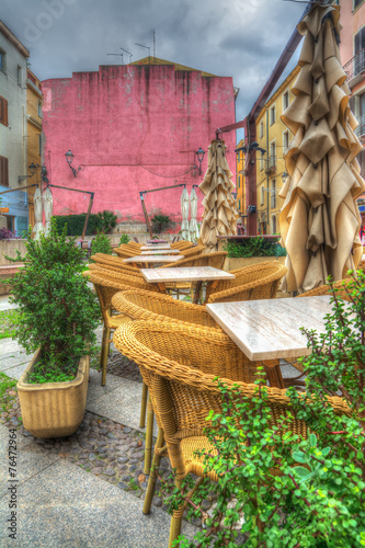 tables and chairs in a small italian square © Gabriele Maltinti