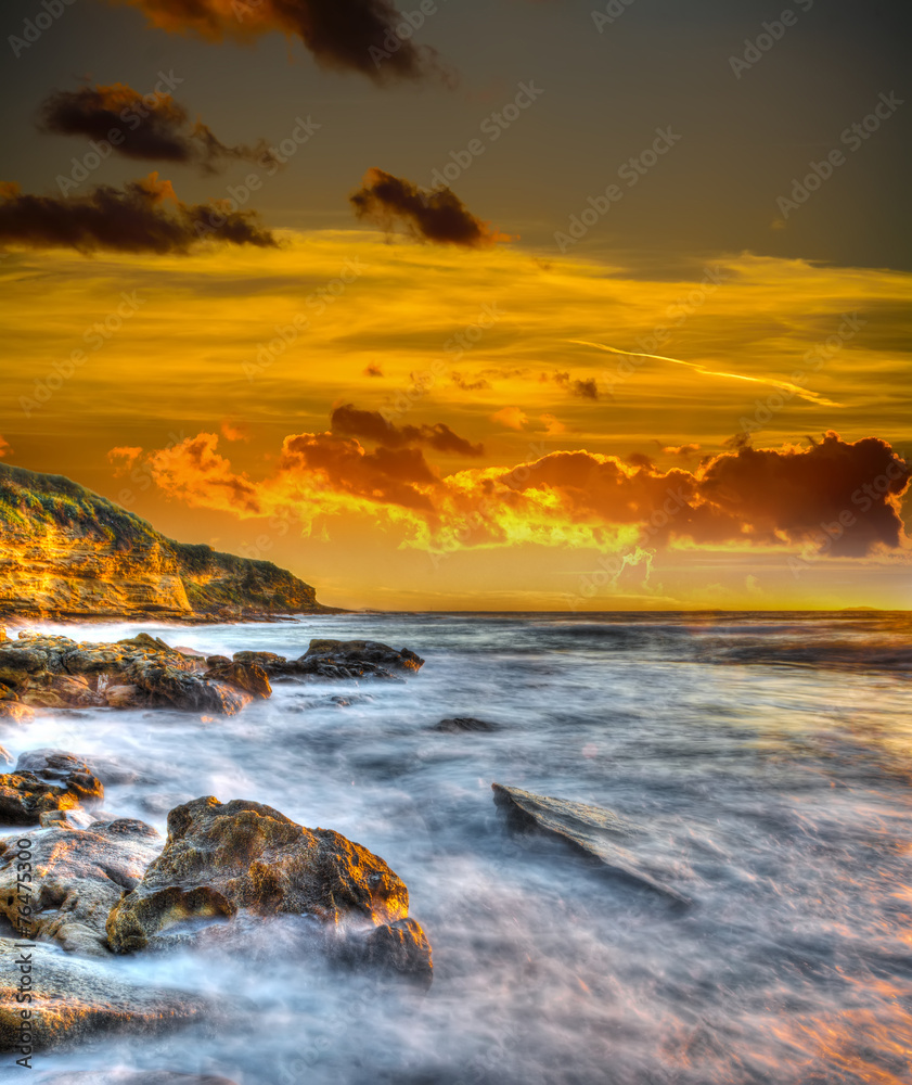rocky coast under a scenic sky at sunset