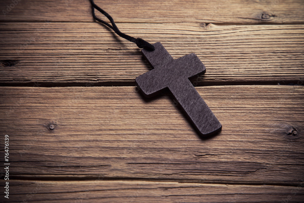 wooden cross on wood background