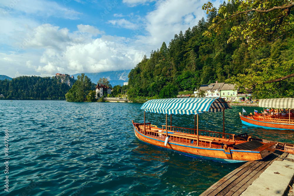 Fototapeta premium Traditional wooden boats Pletna on lake Bled