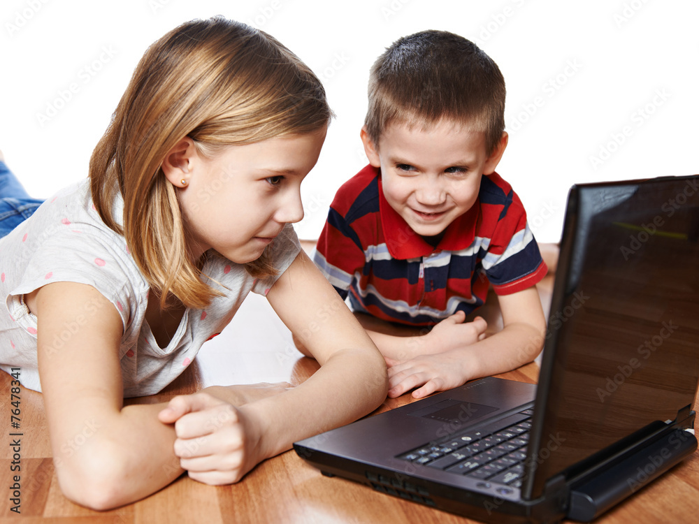 Sister and brother looking to laptop Sister and brother looking to laptop