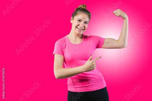 Fit woman pointing on her bicep © innervisionpro