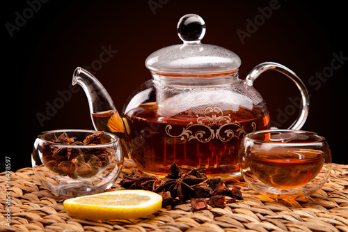 Cup of tea with teapot. With lemon and star anise