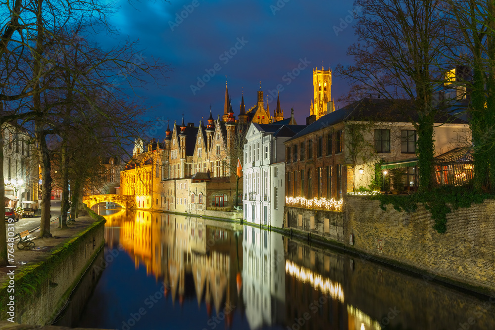 Night cityscape with a tower Belfort and the Green canal in Brug
