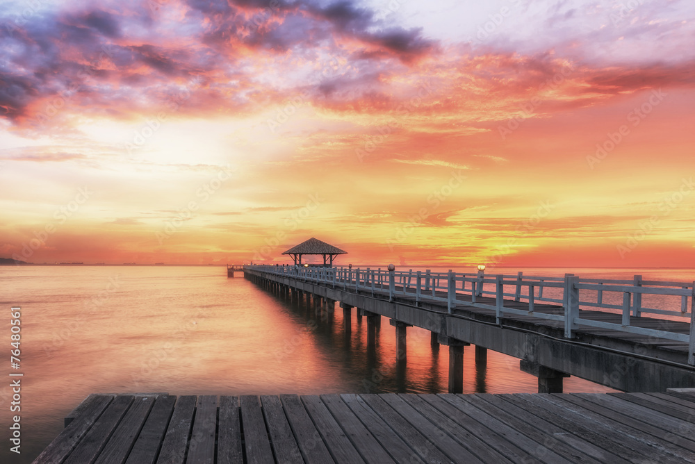 Fototapeta premium Landscape of Wooded bridge in the port between sunrise