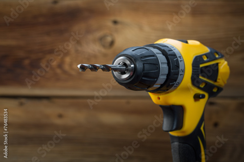 electric drill on a wooden background photo