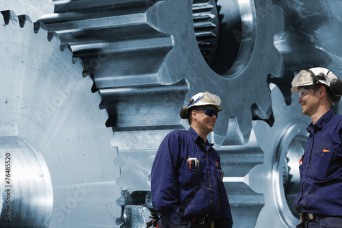 engineers with titanium and steel cogwheels and gears photo