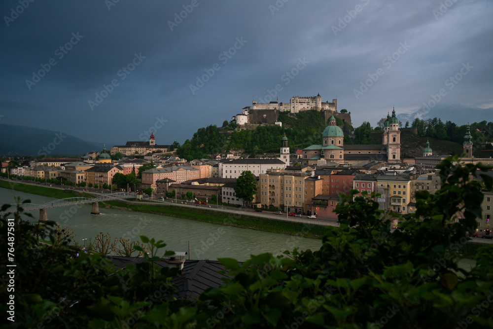 Salzburg r with dramatic cloudscape during blue hour, Austria