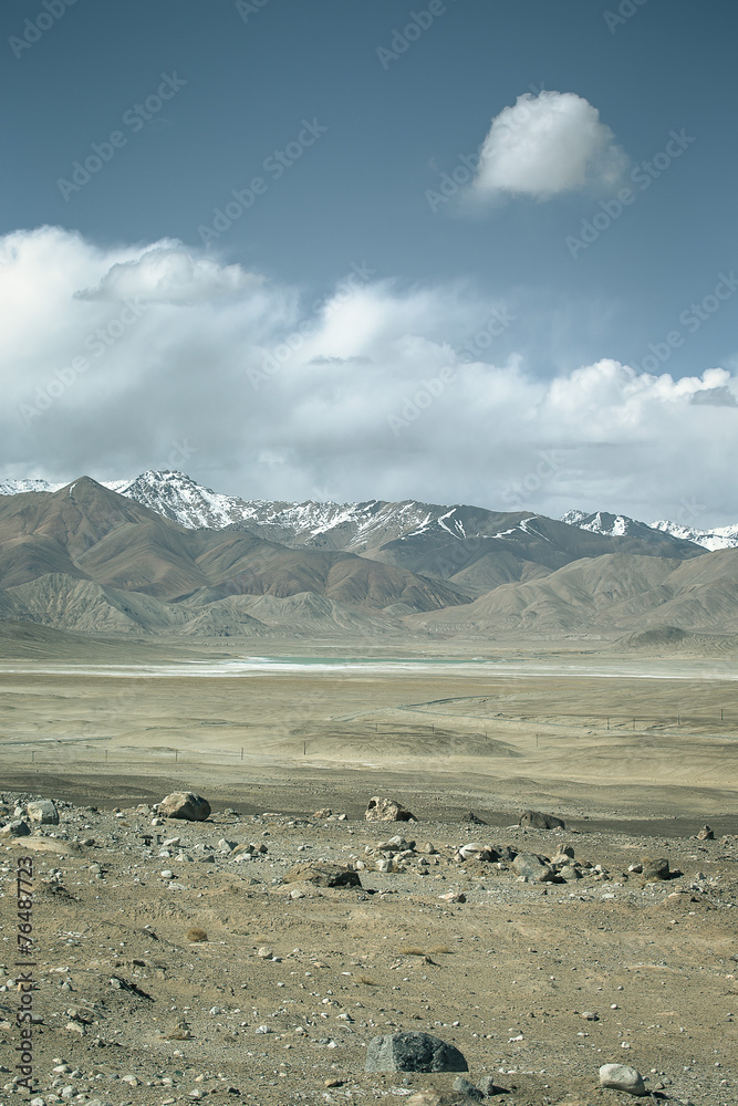 The valley at the foot of the mountains on Pamir. Spring. Tajiki The valley at the foot of the mountains on Pamir. Spring. Tajiki