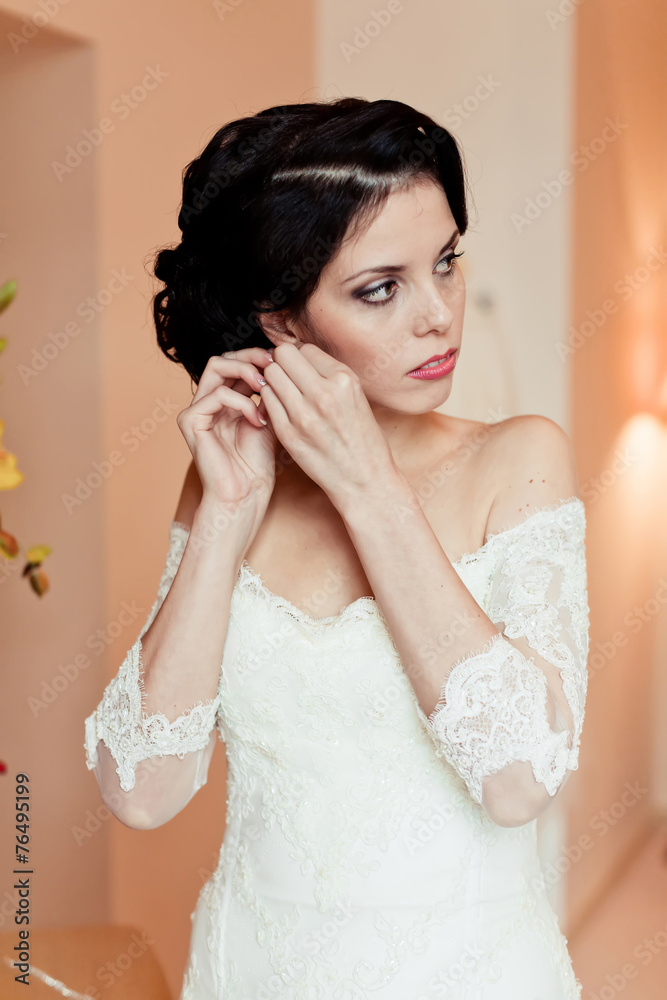 Gorgeous bride on her wedding day, wear earrings, morning bride Gorgeous bride on her wedding day, wear earrings, morning bride