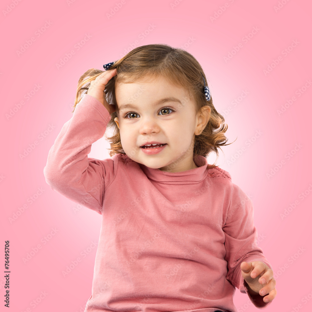 Little girl over pink background