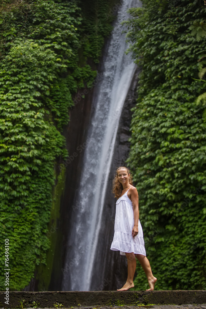 woman meditating doing yoga between waterfalls woman meditating doing yoga between waterfalls