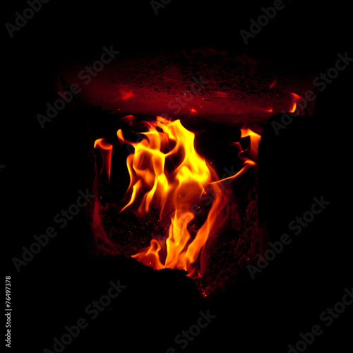 Flames erupt from the combustion chamber of the furnace