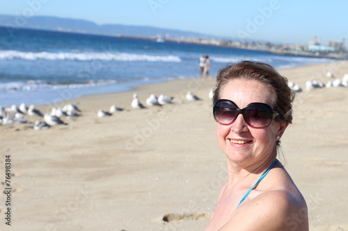 Portrait of an elder woman smiling at the beach