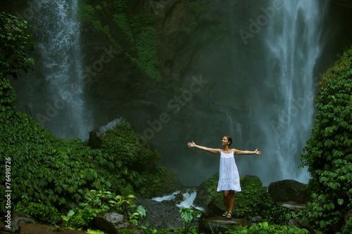 woman meditating doing yoga between waterfalls