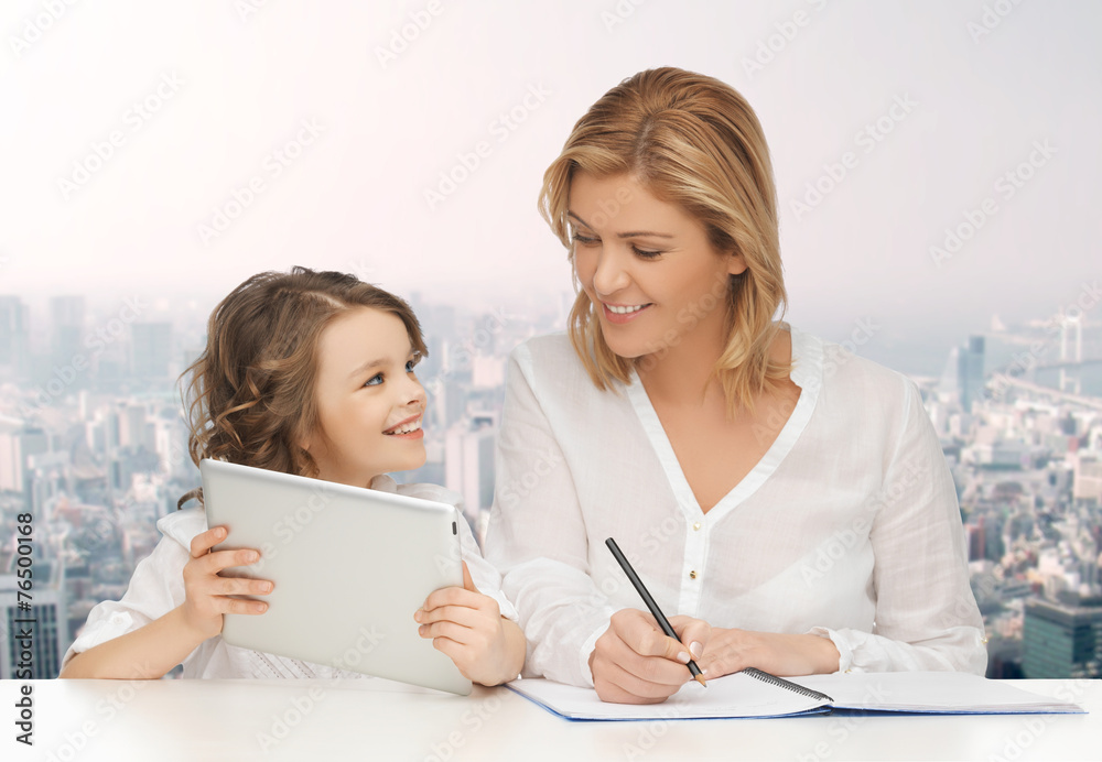 woman with notebook and girl holding tablet pc woman with notebook and girl holding tablet pc