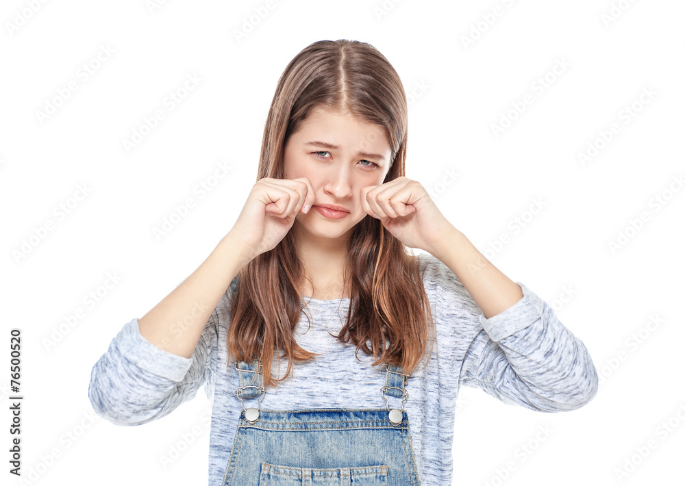 Crying young teenage girl in jeans overalls isolated Crying young teenage girl in jeans overalls isolated