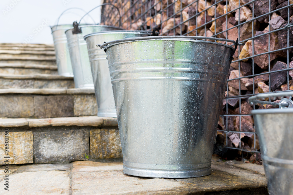 Wet Metal Buckets on stairs
