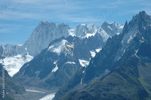 Paraglider and peaks nearby Chamonix in Alps in France