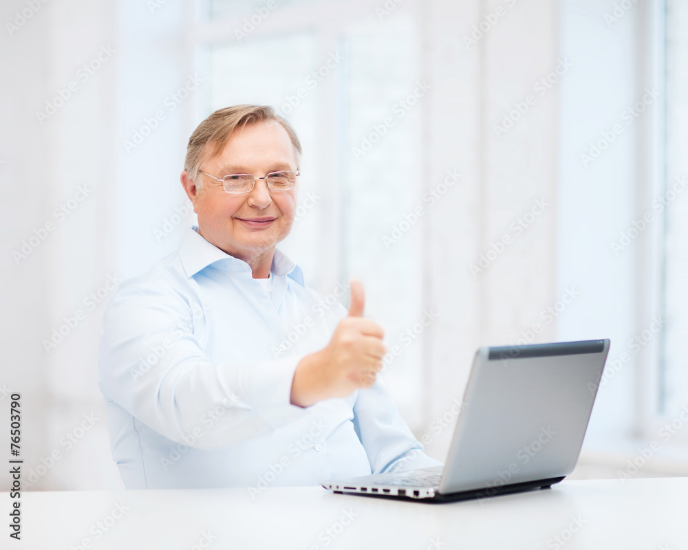 old man with laptop computer showing thumbs up old man with laptop computer showing thumbs up