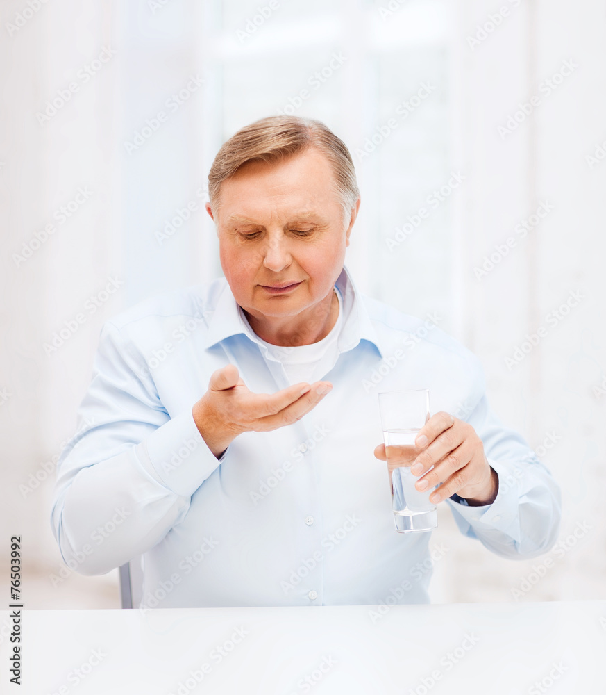 old man with pills ang glass of water