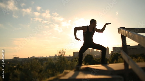 Man dancing at sunset