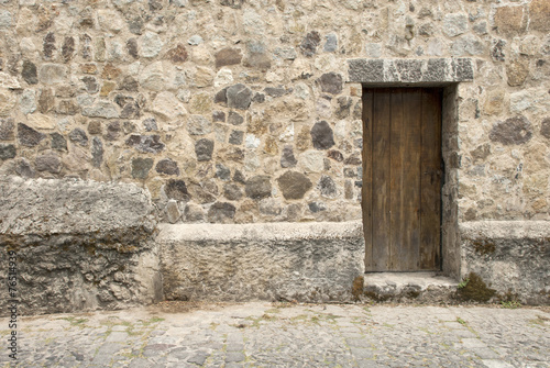 Fototapeta Naklejka Na Ścianę i Meble -  Spanish Colonial Style - Wooden Door And Stone Wall