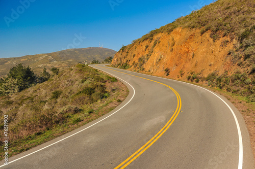 Road with an curve through hills