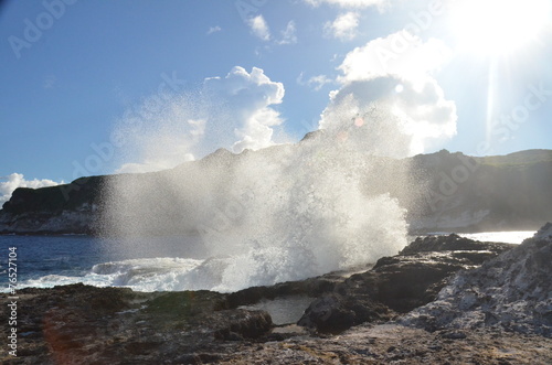 Wave crashing on stones