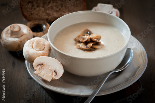 Mushroom cream soup on a wooden background