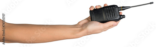 Female hand holding portable radio transmitter