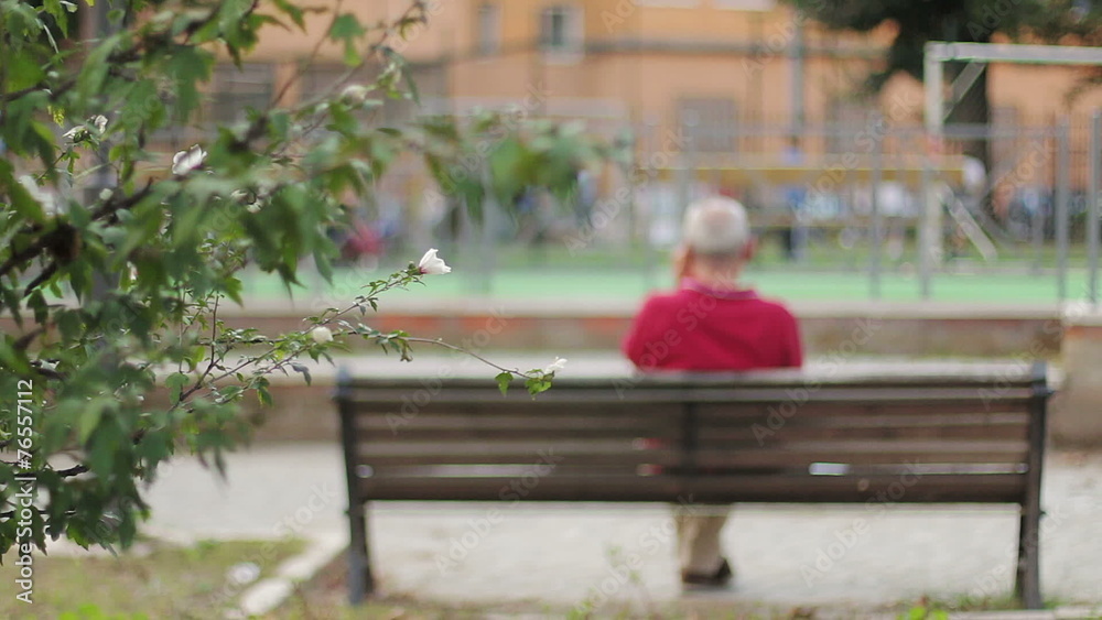 Lonely and sad old men on a bench, backfacing