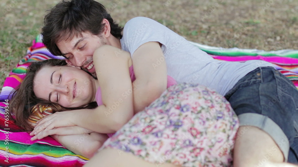 tenderness, two lovers embraced on the lawn exchange kisses and laugh tenderness, two lovers embraced on the lawn exchange kisses and laugh