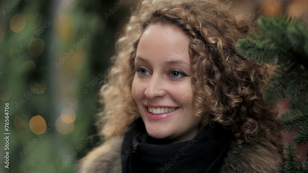 portrait of a beautiful woman smiling Christmas decorations in the background