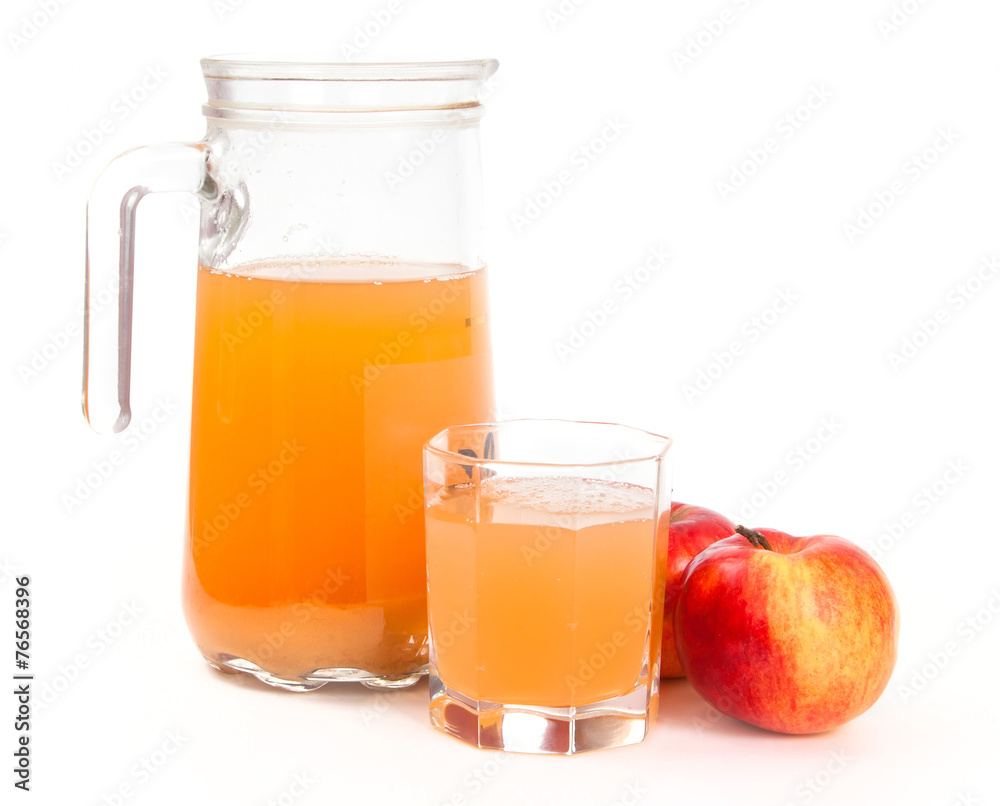 Jug of freshly squeezed apple juice, glass and two apples Jug of freshly squeezed apple juice, glass and two apples