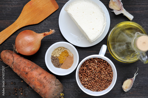 Ingredients for cooking buckwheat with cheese and carrot. photo