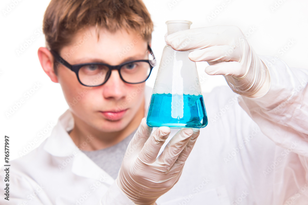 Chemist holding test tube in labolatory during reaction Chemist holding test tube in labolatory during reaction