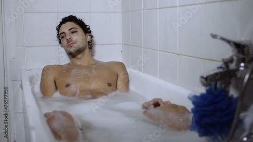 man relaxes in bathtub - relax - shower photo