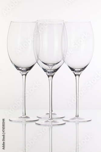 Four wine glasses on a glass desk
