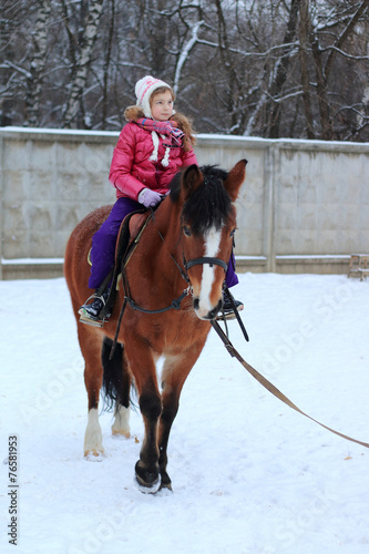 Girl on a horse in winter