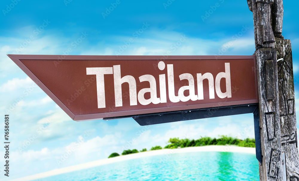 Thailand wooden sign with a beach on background