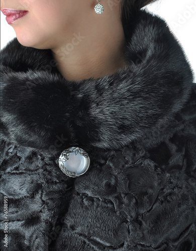 Fragment of female fur coat black.