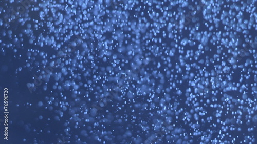 Dark blue underwater abyss shot with bubbles moving left to righ
