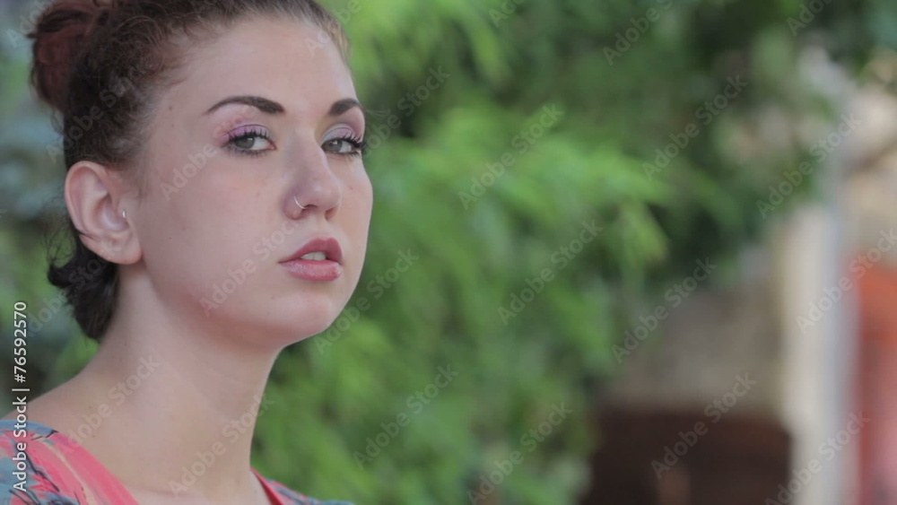 beautiful woman lights a cigarette and smokes Looking at the Camera beautiful woman lights a cigarette and smokes Looking at the Camera